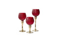 Three red glass goblets with gold bases on a white background