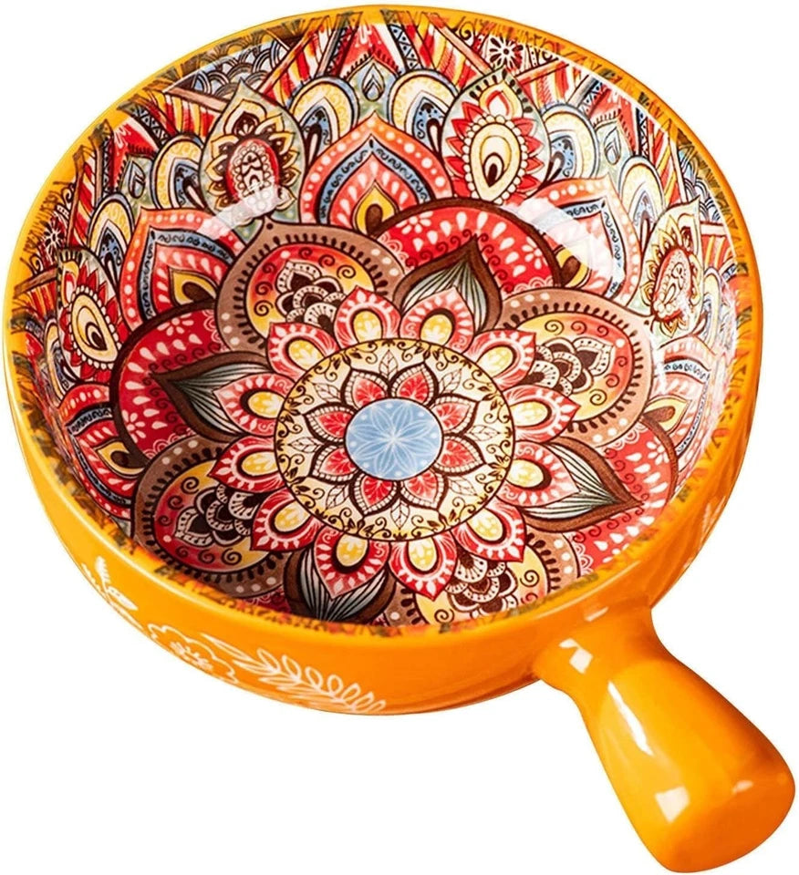 Decorative bowl with intricate patterns and an orange handle on a white background