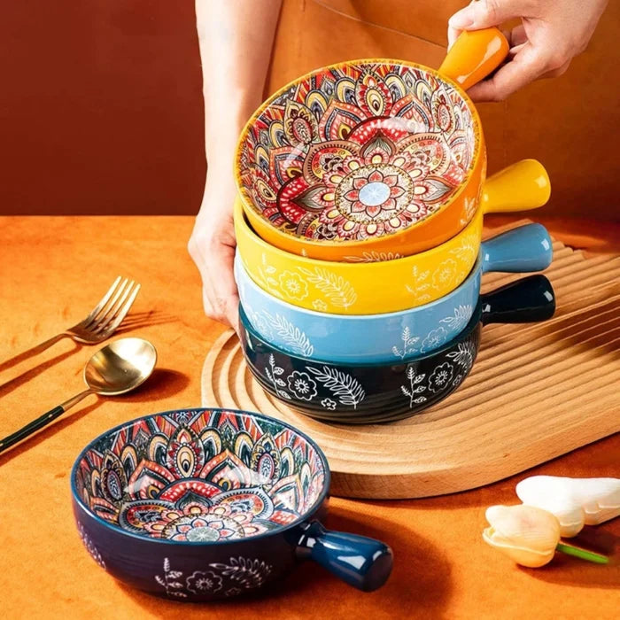Stack of colorful ceramic bowls with floral patterns on a wooden surface.