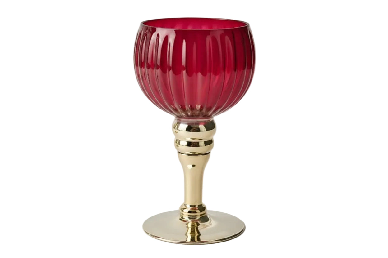 Gold candle holder with a red glass base on a white background