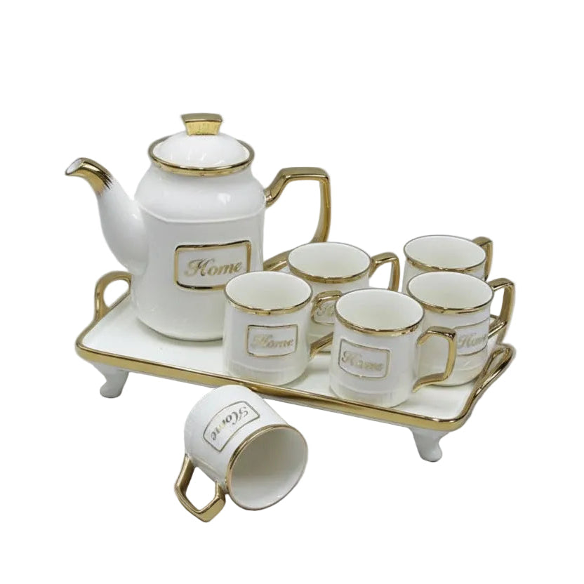 Ceramic tea set with teapot and cups on a tray against a red background